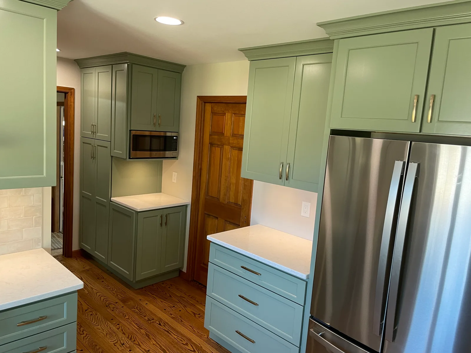 From oak and wallpaper to sage and stone — the finished result by Mac Kitchens